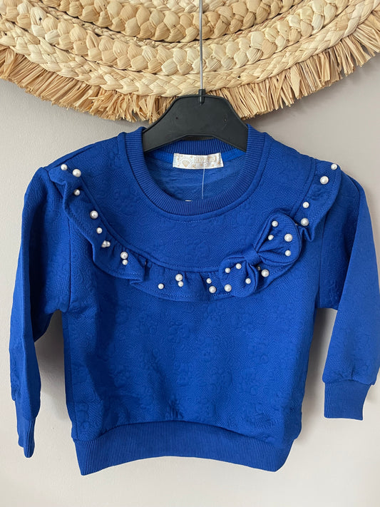 Pull bleu avec perle et noeud